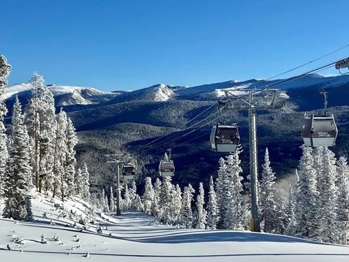 A serene view of snow-covered trees, a ski lift, and a majestic mountain range. The image conveys the excitement of outdoor activities and the beauty of the surrounding landscape, inviting exploration beyond the home.